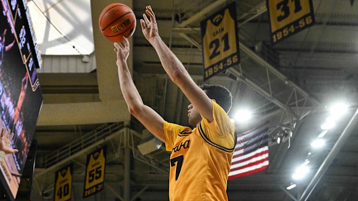 Feb 8, 2026; Iowa City, Iowa, USA; Iowa Hawkeyes forward Alvaro Folgueiras (7) shoots the ball over Northwestern Wildcats forward Nick Martinelli (2) during the second half at Carver-Hawkeye Arena. Mandatory Credit: Jeffrey Becker-Imagn Images