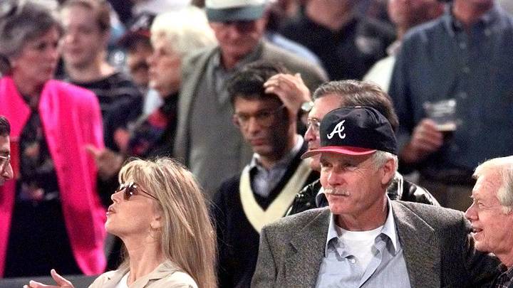 Oct. 16, 1996; Atlanta, GA, USA; Atlanta Braves owner Ted Turner greets former President Jimmy Carter before the start of game 6 of the NLCS. At left is Turner's wife, Jane Fonda. Mandatory Credit: Robert Hanashiro/USA TODAY NETWORK