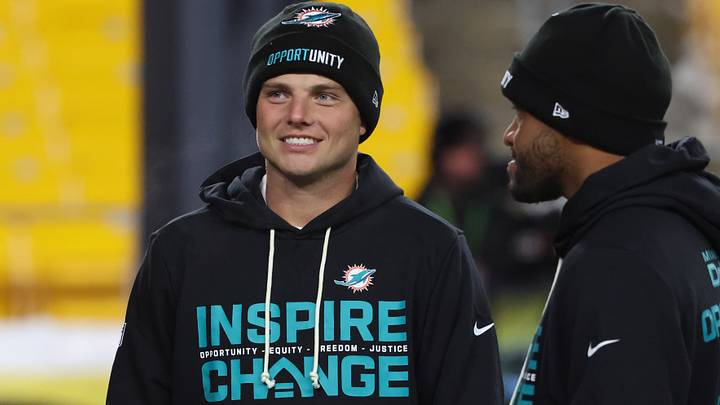 Dec 15, 2025; Pittsburgh, Pennsylvania, USA;  Miami Dolphins quarterbacks Zach Wilson (0), left, and Tua Tagovailoa (1), right, talk on the field before the game against the Pittsburgh Steelers at Acrisure Stadium.