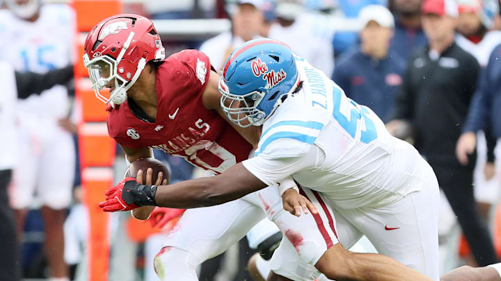 Arkansas Razorbacks quarterback Taylen Green gets tackled by Ole Miss Rebels nose tackle Zxavian Harris 