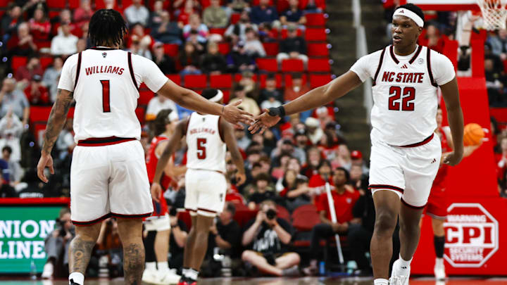 Dec 6, 2025; Raleigh, North Carolina, USA; NC State Wolfpack forward Darrion Williams (1) and forward Ven-Allen Lubin (22) high five during the second half of the game against the Liberty Flames at Lenovo Center. Mandatory Credit: Jaylynn Nash-Imagn Images