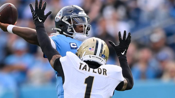 Dec 28, 2025; Nashville, Tennessee, USA;  New Orleans Saints cornerback Alontae Taylor (1) hits Tennessee Titans quarterback Cameron Ward (1) as he throws a pass during the second half at Nissan Stadium. Mandatory Credit: Steve Roberts-Imagn Images