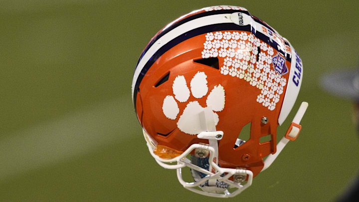 Dec 19, 2020; Charlotte, NC, USA;  Clemson Tigers quarterback Trevor Lawrence (16) tosses his helmet to a manager after the ACC Football Championship at Bank of America Stadium. Mandatory Credit: Bob Donnan-Imagn Images