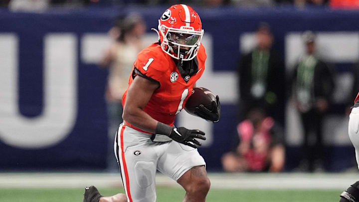 Dec 7, 2024; Atlanta, GA, USA; Georgia Bulldogs running back Trevor Etienne (1) rushes the ball against the Texas Longhorns during the first half in the 2024 SEC Championship game at Mercedes-Benz Stadium. 