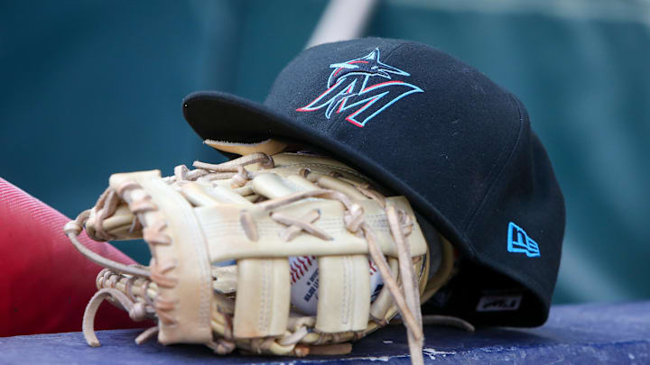 Apr 24, 2024; Atlanta, Georgia, USA; A detailed view of a Miami Marlins hat and glove in the dugout before a game against the Atlanta Braves at Truist Park.