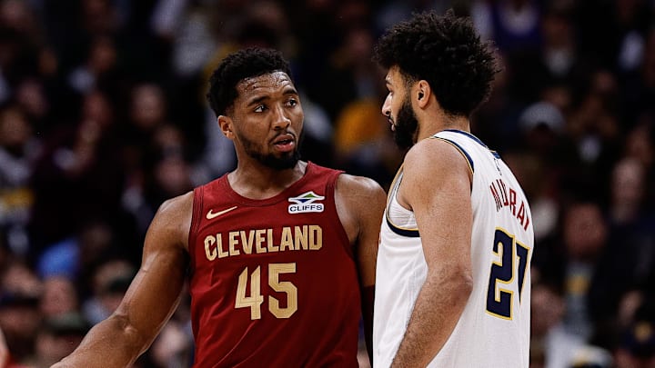 Dec 27, 2024; Denver, Colorado, USA; Cleveland Cavaliers guard Donovan Mitchell (45) talks with Denver Nuggets guard Jamal Murray (27) after a play in the third quarter at Ball Arena.