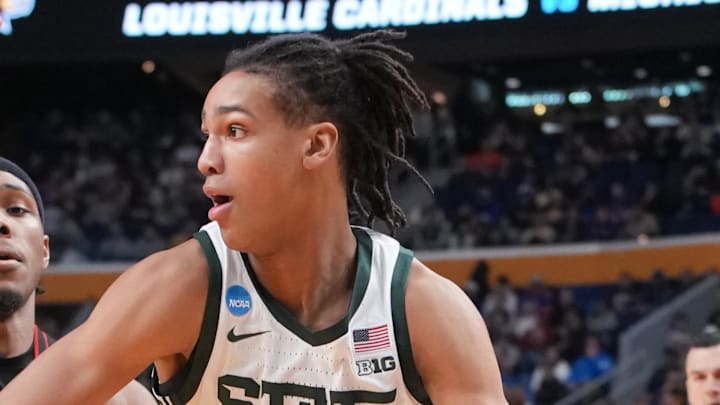Mar 21, 2026; Buffalo, NY, USA; Michigan State Spartans forward Jordan Scott (6) drives the ball while defended by Louisville Cardinals guard Ryan Conwell (3) in the second half during a second round game of the men's 2026 NCAA Tournament at Keybank Center. Mandatory Credit: Gregory Fisher-Imagn Images Mar 21, 2026; Buffalo, NY, USA; Michigan State Spartans forward Jordan Scott (6) drives the ball while defended by Louisville Cardinals guard Ryan Conwell (3) in the second half during a second round game of the men's 2026 NCAA Tournament at Keybank Center. Mandatory Credit: Gregory Fisher-Imagn Images