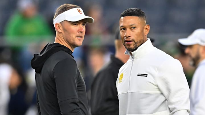 Oct 14, 2023; South Bend, Indiana, USA; USC Trojans head coach Lincoln Riley and Notre Dame Fighting Irish head coach Marcus Freeman chat before the game at Notre Dame Stadium. Mandatory Credit: Matt Cashore-Imagn Images