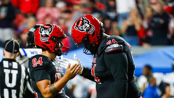 Nov 9, 2024; Raleigh, North Carolina, USA; North Carolina State Wolfpack place kicker Kanoah Vinesett (94) and offensive tackle Anthony Belton (74) celebrate during the second half of the game against Duke Blue Devils at Carter-Finley Stadium. Mandatory Credit: Jaylynn Nash-Imagn Images Nov 9, 2024; Raleigh, North Carolina, USA; North Carolina State Wolfpack place kicker Kanoah Vinesett (94) and offensive tackle Anthony Belton (74) celebrate during the second half of the game against Duke Blue Devils at Carter-Finley Stadium. Mandatory Credit: Jaylynn Nash-Imagn Images