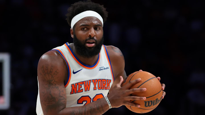 Nov 17, 2025; Miami, Florida, USA; New York Knicks center Mitchell Robinson (23) protects the basketball against the Miami Heat during the third quarter at Kaseya Center. Mandatory Credit: Sam Navarro-Imagn Images