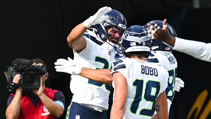 Aug 10, 2024; Inglewood, California, USA; Seattle Seahawks running back George Holani (36) celebrates with teammates after making a touchdown against the Los Angeles Chargers during the second quarter at SoFi Stadium. Mandatory Credit: Jonathan Hui-Imagn Images