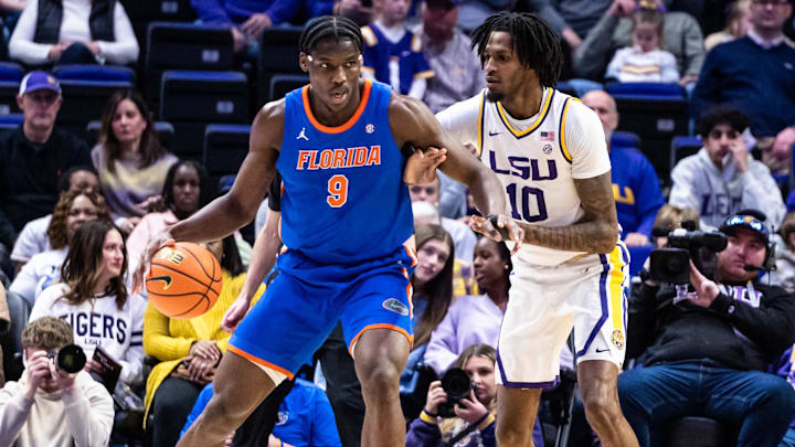 Feb 22, 2025; Baton Rouge, Louisiana, USA; Florida Gators center Rueben Chinyelu (9) dribbles against LSU Tigers forward Daimion Collins (10) during the first half at Pete Maravich Assembly Center. Mandatory Credit: Stephen Lew-Imagn Images