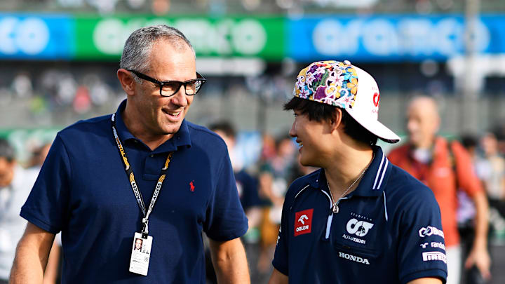 Yuki Tsunoda of Japan and Scuderia AlphaTauri talks with Stefano Domenicali, CEO of the Formula One Group, during previews ahead of the F1 Grand Prix of Japan at Suzuka International Racing Course on September 21, 2023 in Suzuka, Japan. 