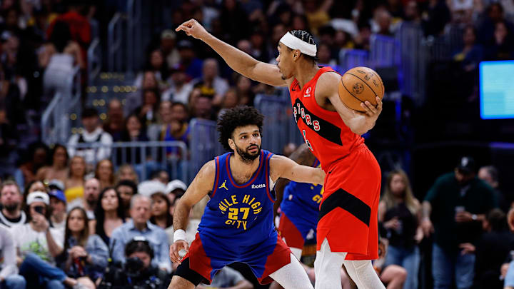 Mar 20, 2026; Denver, Colorado, USA; Toronto Raptors forward Scottie Barnes (4) controls the ball as Denver Nuggets guard Jamal Murray (27) guards in the third quarter at Ball Arena. Mandatory Credit: Isaiah J. Downing-Imagn Images