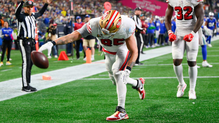 Oct 10, 2024; Seattle, Washington, USA; San Francisco 49ers tight end George Kittle (85) spikes the ball after scoring a touchdown against the Seattle Seahawks during the second half at Lumen Field. Mandatory Credit: Steven Bisig-Imagn Images