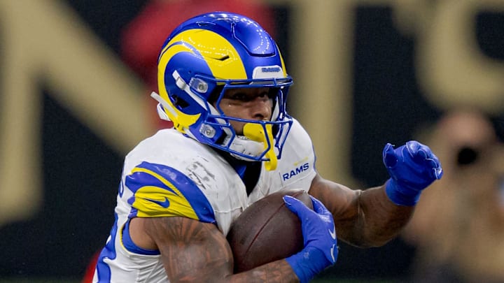 Dec 1, 2024; New Orleans, Louisiana, USA; Los Angeles Rams running back Kyren Williams (23) is tackled by New Orleans Saints safety Ugo Amadi (0) during the first half at Caesars Superdome. Mandatory Credit: Matthew Hinton-Imagn Images