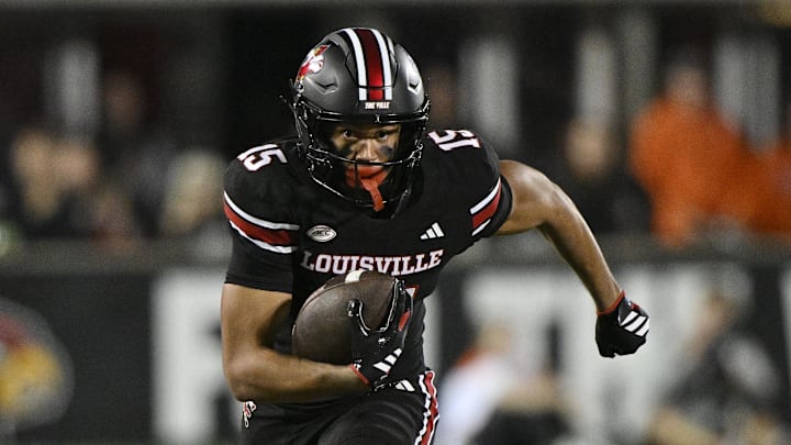 Nov 14, 2025; Louisville, Kentucky, USA;  Louisville Cardinals wide receiver Antonio Meeks (15) runs the ball against Clemson Tigers cornerback Branden Strozier (1) during the second half at L&N Federal Credit Union Stadium. Clemson defeated Louisville 20-19. Mandatory Credit: Jamie Rhodes-Imagn Images
