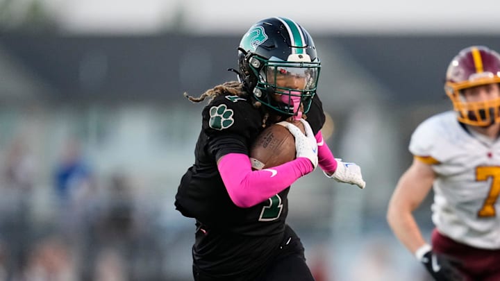 Oct 4, 2024; Galloway, Ohio, USA; Westland ATH Emoni Smith (1) rushes upfield past Westerville North DB Trey McDonald (7) during the first half of the OHSAA football game at Westland High School.