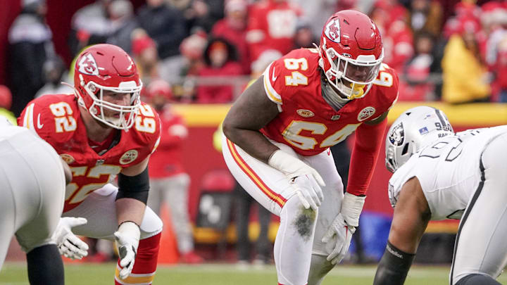 Dec 25, 2023; Kansas City, Missouri, USA; Kansas City Chiefs guard Joe Thuney (62) and offensive tackle Wanya Morris (64) at the line of scrimmage against the Las Vegas Raiders during the game at GEHA Field at Arrowhead Stadium. Mandatory Credit: Denny Medley-Imagn Images