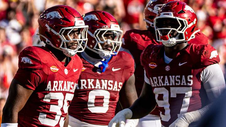 Arkansas Razorbacks defensive linemen Steven Soles, Hunter Osbone and Quincy Rhodes celebrate after a stop against Tennessee Volunteers. Arkansas Razorbacks defensive linemen Steven Soles, Hunter Osbone and Quincy Rhodes celebrate after a stop against Tennessee Volunteers.