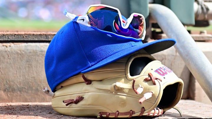 Feb 27, 2024; Mesa, Arizona, USA;  General view of a Chicago Cubs glove, hat and glasses in the first inning against the Cincinnati Reds during a spring training game at Sloan Park. 