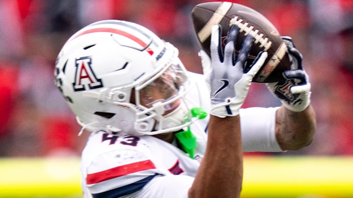 Arizona Wildcats defensive back Dalton Johnson (43) intercepts a pass intended for Cincinnati Bearcats wide receiver Cyrus Allen (4) in the second quarter of the NCAA football game between the Cincinnati Bearcats and Arizona Wildcats at Nippert Stadium in Cincinnati on Nov. 15, 2025.