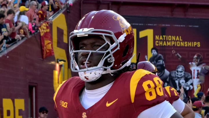 Oct 11, 2025; Los Angeles, California, USA; USC Trojans head coach Lincoln Riley, center, runs on to the field for the game against the Michigan Wolverines at United Airlines Field at the Los Angeles Memorial Coliseum. Mandatory Credit: Jayne Kamin-Oncea-Imagn Images