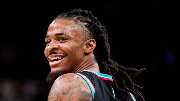 Dec 12, 2025; Memphis, Tennessee, USA; Memphis Grizzlies point guard Ja Morant (12) smiles at the Utah Jazz bench after forcing a turnover in the second half at FedExForum. Mandatory Credit: Matthew Smith-Imagn Images