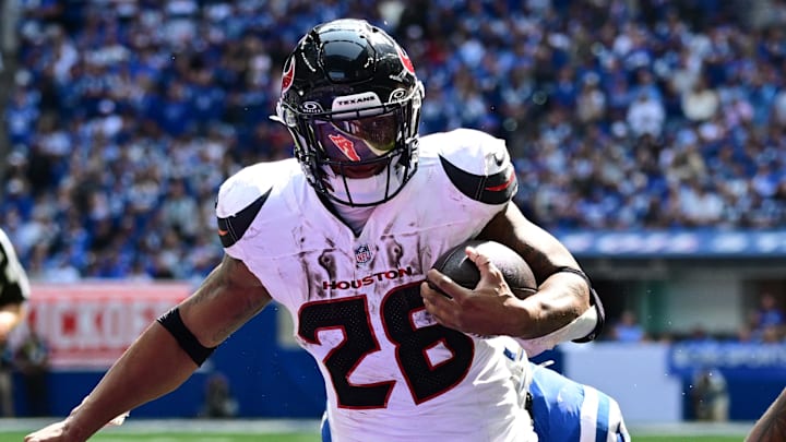 Sep 8, 2024; Indianapolis, Indiana, USA; Houston Texans running back Joe Mixon (28) runs the ball in for a touchdown in front of Indianapolis Colts cornerback Jaylon Jones (40) during the second half at Lucas Oil Stadium. Mandatory Credit: Marc Lebryk-Imagn Images