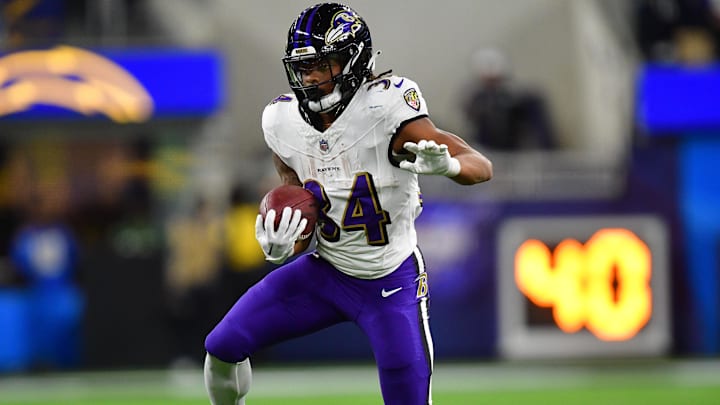 Nov 26, 2023; Inglewood, California, USA; Baltimore Ravens running back Keaton Mitchell (34) runs the ball ahead of Los Angeles Chargers cornerback Asante Samuel Jr. (26) during the first half at SoFi Stadium. Mandatory Credit: Gary A. Vasquez-Imagn Images Nov 26, 2023; Inglewood, California, USA; Baltimore Ravens running back Keaton Mitchell (34) runs the ball ahead of Los Angeles Chargers cornerback Asante Samuel Jr. (26) during the first half at SoFi Stadium. Mandatory Credit: Gary A. Vasquez-Imagn Images