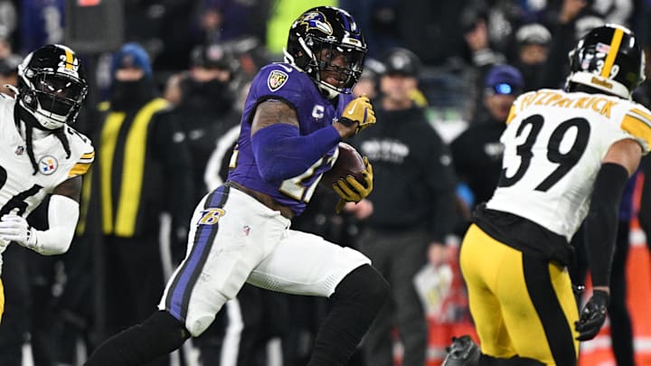 Jan 11, 2025; Baltimore, Maryland, USA; Baltimore Ravens running back Derrick Henry (22) runs against Pittsburgh Steelers safety Minkah Fitzpatrick (39) in the second quarter in an AFC wild card game at M&T Bank Stadium. Mandatory Credit: Tommy Gilligan-Imagn Images