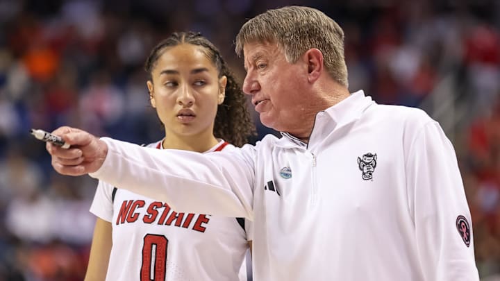 Mar 9, 2025; Greensboro, NC, USA;  NC State Wolfpack head coach Wes Moore talks with NC State Wolfpack guard Devyn Quigley (0) during the fourth quarter against Duke Blue Devils at First Horizon Coliseum. Mandatory Credit: Cory Knowlton-Imagn Images