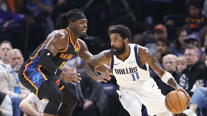Nov 17, 2024; Oklahoma City, Oklahoma, USA; Dallas Mavericks guard Kyrie Irving (11) moves the ball around Oklahoma City Thunder guard Luguentz Dort (5) during the second half at Paycom Center. Mandatory Credit: Alonzo Adams-Imagn Images