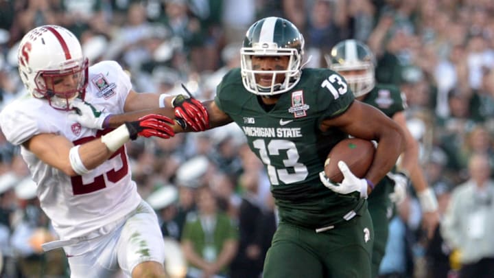 Jan 1, 2014; Pasadena, CA, USA; Michigan State Spartans receiver Bennie Fowler (13) is defended by Stanford Cardinal safety Ed Reynolds (29) on a 60-yard reception in the third quarter in the 100th Rose Bowl. Michigan State defeated Stanford 24-20. Mandatory Credit: Kirby Lee-Imagn Images