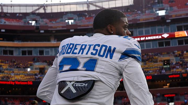 Nov 9, 2025; Landover, Maryland, USA; Detroit Lions cornerback Amik Robertson (21) kneels on the field during warmups prior to a game against the Washington Commanders at Northwest Stadium. Mandatory Credit: Peter Casey-Imagn Images
