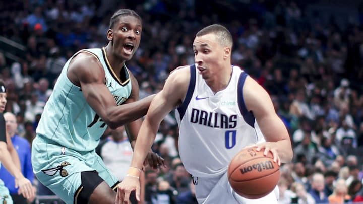 Feb 27, 2025; Dallas, Texas, USA;  Dallas Mavericks guard Dante Exum (0) drives to the basket as Charlotte Hornets guard Wendell Moore Jr. (14) defends during the second half at American Airlines Center. Mandatory Credit: Kevin Jairaj-Imagn Images