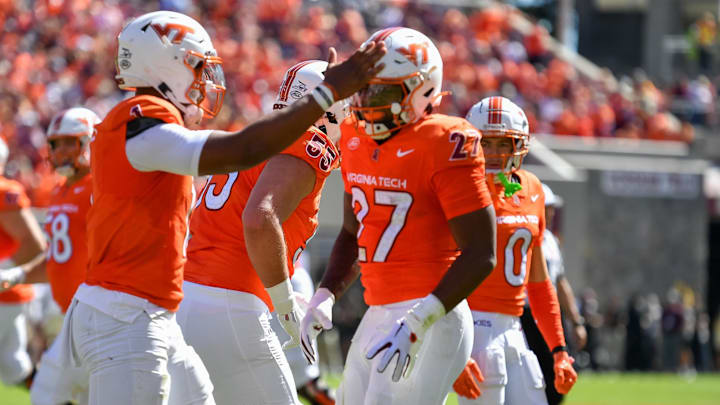 Oct 4, 2025; Blacksburg, Va.; Virginia Tech running back Marcellous Hawkins (27) celebrates with quarterback Kyron Drones (1).