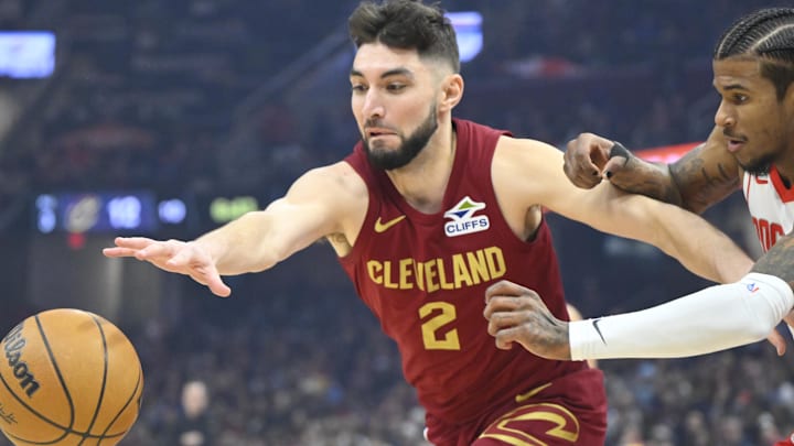 Jan 25, 2025; Cleveland, Ohio, USA; Cleveland Cavaliers guard Ty Jerome (2) and Houston Rockets guard Jalen Green (4) reach for a loose ball in the first quarter at Rocket Mortgage FieldHouse. Mandatory Credit: David Richard-Imagn Images