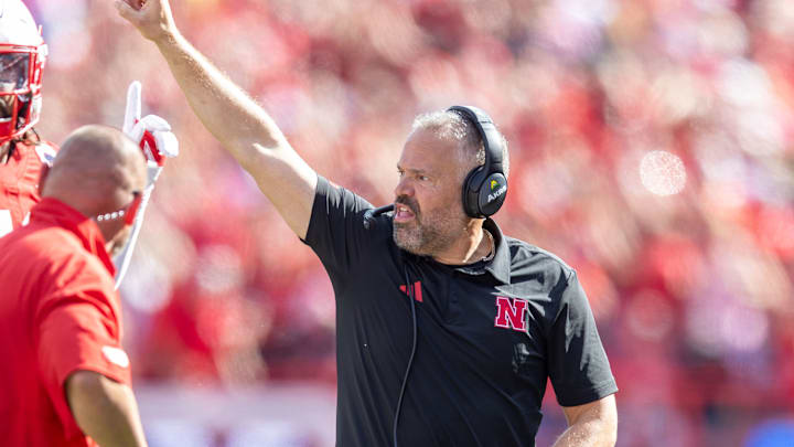 Nebraska head coach Matt Rhule signals for an exta-point kick after the Huskers' Hail Mary touchdown at the end of the first half against Michigan.