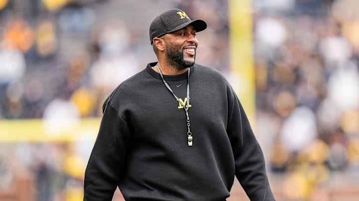 Michigan head coach Sherrone Moore smiles at players as he watches the first half of the spring game at Michigan Stadium in Ann Arbor on Saturday, April 19, 2025.