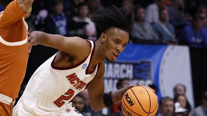 Mar 17, 2026; Dayton, OH, USA; NC State Wolfpack guard Jr. Paul McNeil (2) dribbles defended by Texas Longhorns guard Jordan Pope (0) in the first half during a first four game of the men's 2026 NCAA Tournament at University of Dayton Arena. Mandatory Credit: Rick Osentoski-Imagn Images