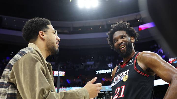 Dec 12, 2025; Philadelphia, Pennsylvania, USA; Philadelphia 76ers center Joel Embiid (21) reacts with injured Indiana Pacers guard Tyrese Haliburton after a win at Xfinity Mobile Arena. Mandatory Credit: Bill Streicher-Imagn Images