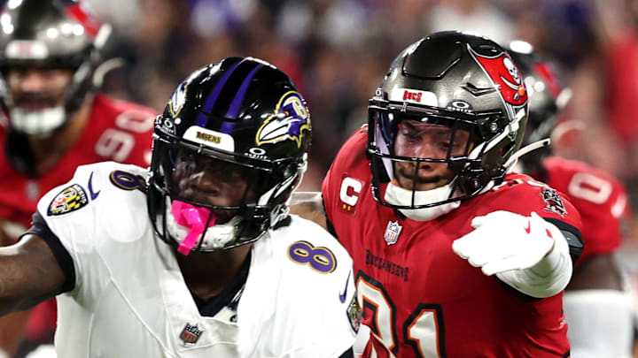 Oct 21, 2024; Tampa, Florida, USA; Baltimore Ravens quarterback Lamar Jackson (8) runs with the ball as Tampa Bay Buccaneers safety Antoine Winfield Jr. (31) defends during the first half at Raymond James Stadium. Mandatory Credit: Kim Klement Neitzel-Imagn Images