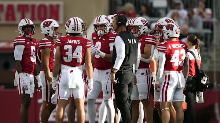 Sep 6, 2025; Madison, Wisconsin, USA;  Wisconsin Badgers head coach Luke Fickell talks with his team during a timeout against the Middle Tennessee Blue Raiders during the second half at Camp Randall Stadium. Mandatory Credit: Kayla Wolf-Imagn Images