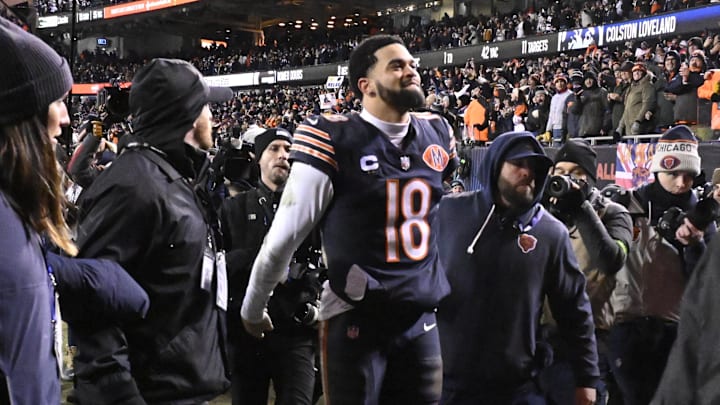 Caleb Williams leaves the field to the locker room after engineering the Bears' comeback from 18 behind to beat the Packers in the playoffs.