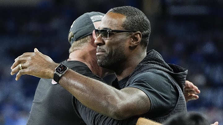 Detroit Lions head coach Dan Campbell, left, hugs Calvin Johnson before the game between Lions and Jaguars