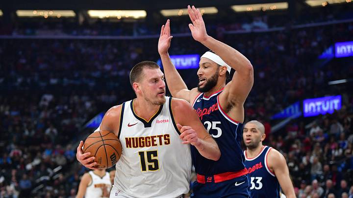 Apr 24, 2025; Inglewood, California, USA; Denver Nuggets center Nikola Jokic (15) moves to the basket against Los Angeles Clippers guard Ben Simmons (25) during the first half of game three in the first round for the 2024 NBA Playoffs at Intuit Dome. Mandatory Credit: Gary A. Vasquez-Imagn Images Apr 24, 2025; Inglewood, California, USA; Denver Nuggets center Nikola Jokic (15) moves to the basket against Los Angeles Clippers guard Ben Simmons (25) during the first half of game three in the first round for the 2024 NBA Playoffs at Intuit Dome. Mandatory Credit: Gary A. Vasquez-Imagn Images