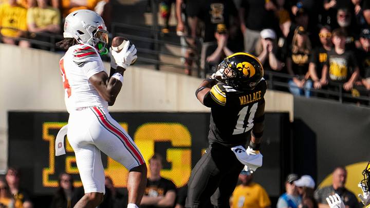 Ohio State Buckeyes wide receiver Jeremiah Smith (4) catches a pass in front of Iowa Hawkeyes defensive back Jacob Wallace (11) during the NCAA football game at Kinnick Stadium in Iowa City on Oct. 3, 2026. Ohio State Buckeyes wide receiver Jeremiah Smith (4) catches a pass in front of Iowa Hawkeyes defensive back Jacob Wallace (11) during the NCAA football game at Kinnick Stadium in Iowa City on Oct. 3, 2026.