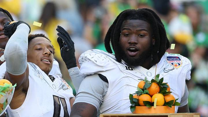 Jan 1, 2026; Miami Gardens, FL, USA; Oregon Ducks quarterback Dante Moore (5), wide receiver Malik Benson (4), defensive back Brandon Finney (4) and defensive lineman Bear Alexander (1) celebrate following the 2025 Orange Bowl and quarterfinal game of the College Football Playoff against the Texas Tech Red Raiders at Hard Rock Stadium. Mandatory Credit: Nathan Ray Seebeck-Imagn Images