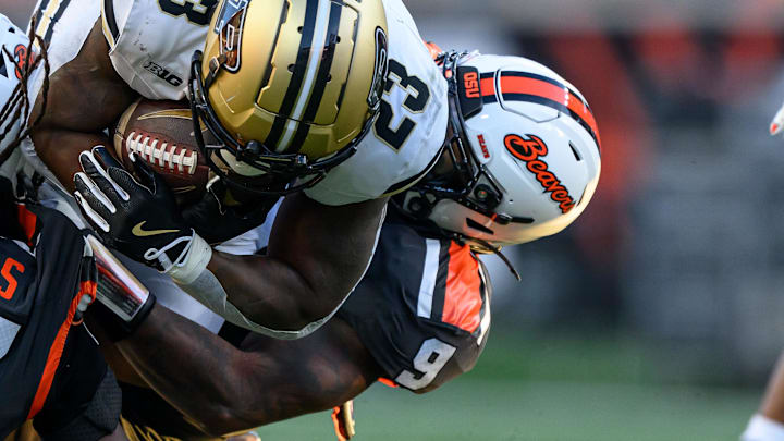 Sep 21, 2024; Corvallis, Oregon, USA; Oregon State Beavers defensive back Skyler Thomas (17) and linebacker Isaiah Chisom (9) stop Purdue Boilermakers running back Reggie Love III (23) on fourth down during the second half at Reser Stadium. Mandatory Credit: Craig Strobeck-Imagn Images